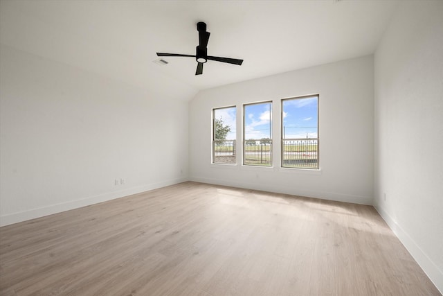 spare room with vaulted ceiling, ceiling fan, and light hardwood / wood-style flooring