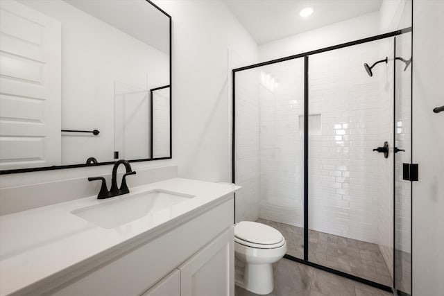 bathroom featuring walk in shower, vanity, and toilet