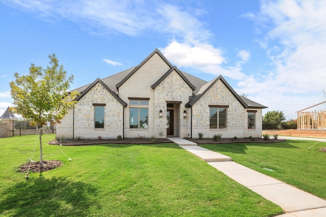 french country style house with a front lawn