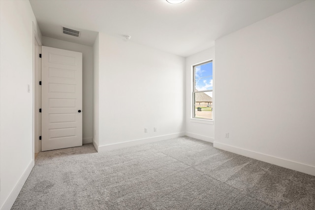 unfurnished room featuring light colored carpet