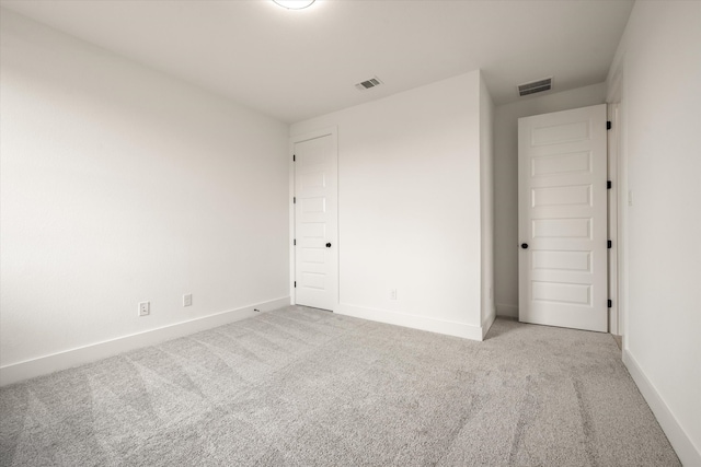 empty room featuring light colored carpet