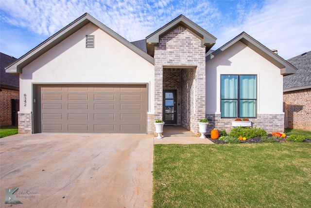 view of front of property with a front yard and a garage