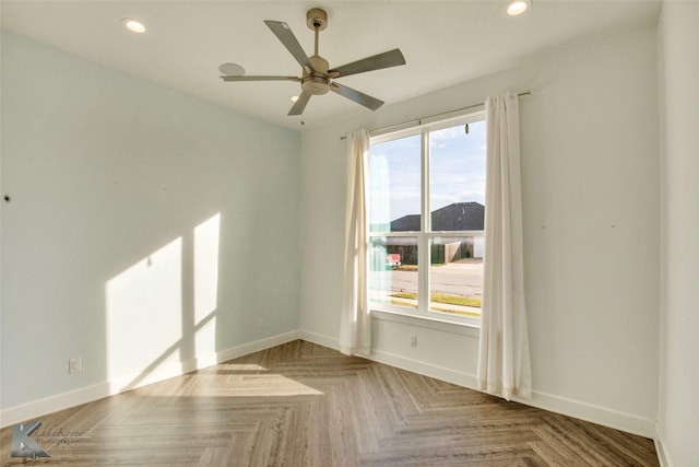 unfurnished room featuring plenty of natural light, parquet floors, and ceiling fan