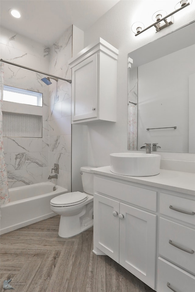 full bathroom featuring vanity, toilet, and tiled shower / bath combo