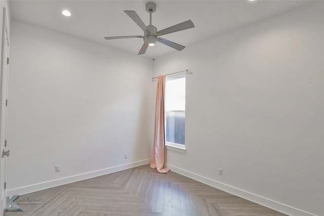 unfurnished room with light parquet flooring and ceiling fan