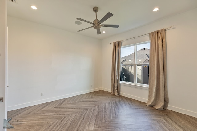 empty room with parquet flooring and ceiling fan