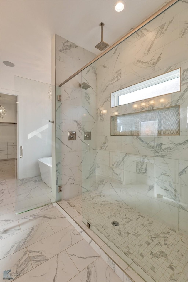 bathroom featuring separate shower and tub