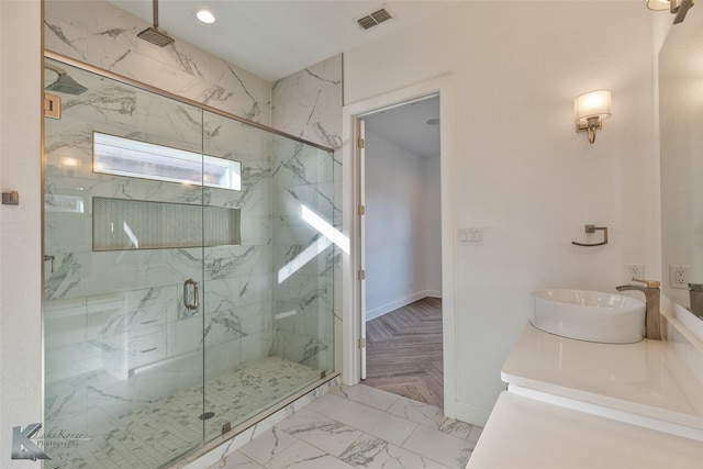 bathroom with an enclosed shower and vanity