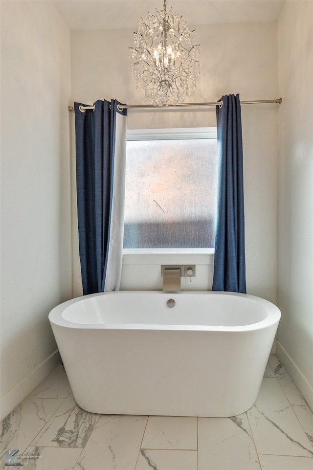 bathroom with a bath and a notable chandelier