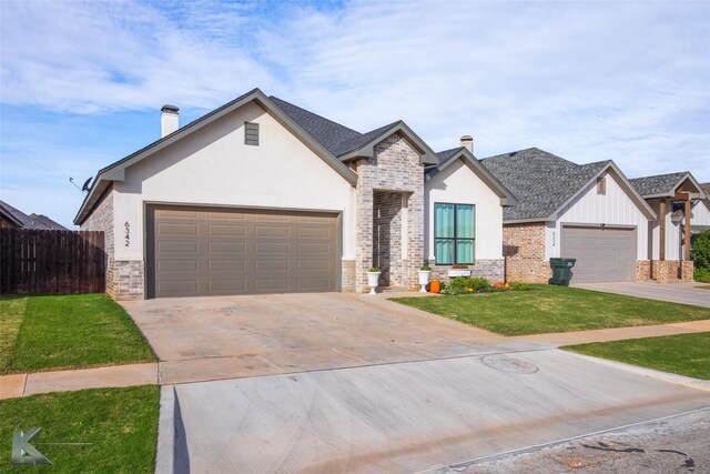 view of front of house featuring a garage and a front lawn