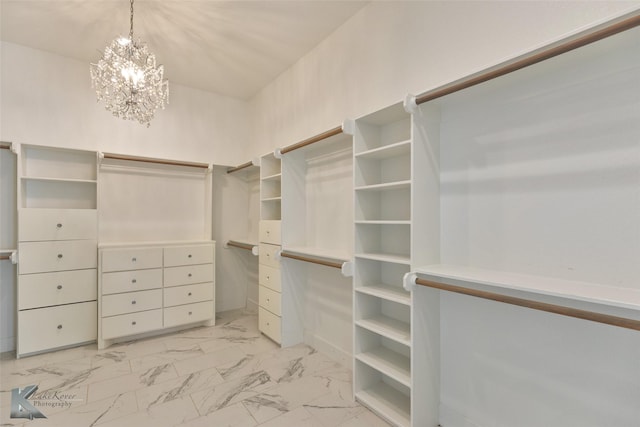 walk in closet with a notable chandelier