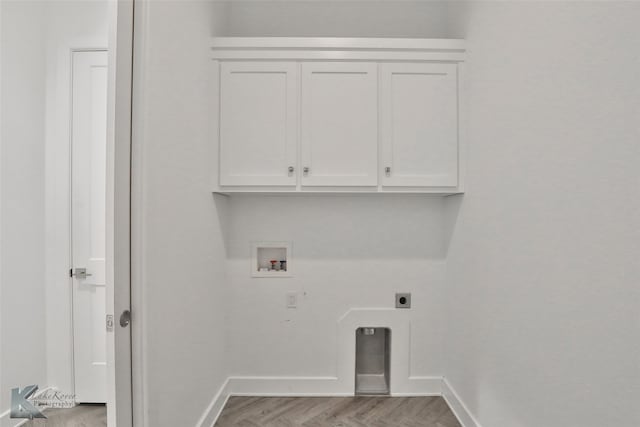 laundry room with cabinets, washer hookup, light hardwood / wood-style floors, and electric dryer hookup