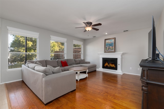 living room featuring ceiling fan, a healthy amount of sunlight, and wood-type flooring