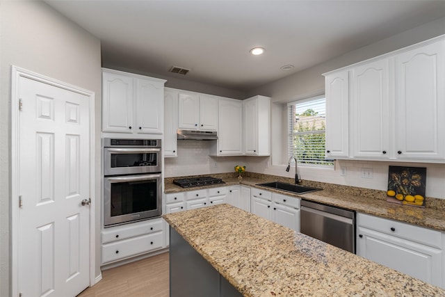 kitchen featuring white cabinetry, sink, and appliances with stainless steel finishes