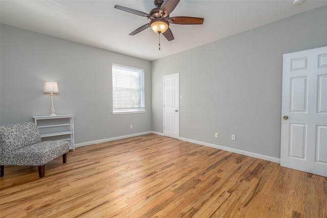 living area featuring ceiling fan and light hardwood / wood-style floors