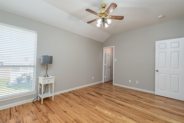 unfurnished room with light hardwood / wood-style floors, vaulted ceiling, and ceiling fan