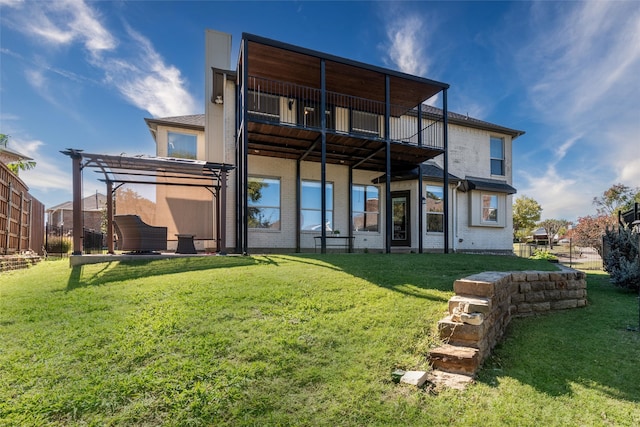 rear view of property featuring a pergola, outdoor lounge area, a balcony, and a yard