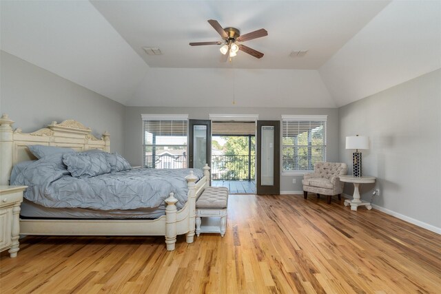 bedroom featuring ceiling fan, vaulted ceiling, light wood-type flooring, and multiple windows