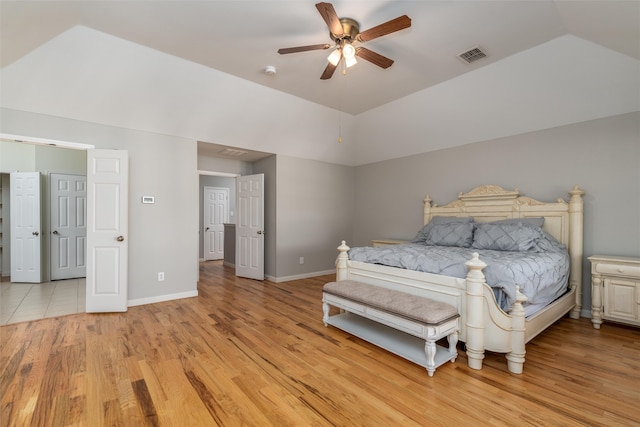 bedroom featuring ceiling fan, light hardwood / wood-style floors, and vaulted ceiling