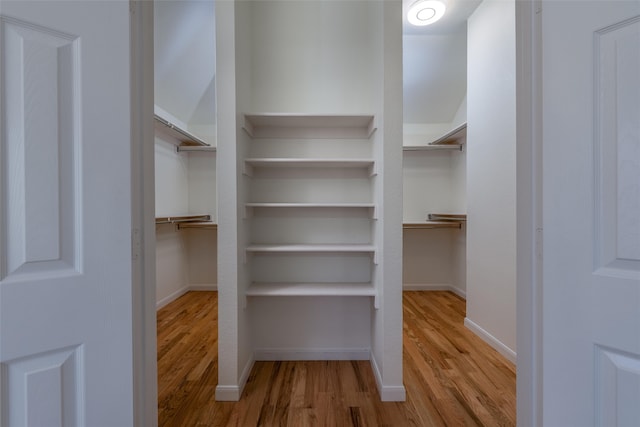 walk in closet with light wood-type flooring