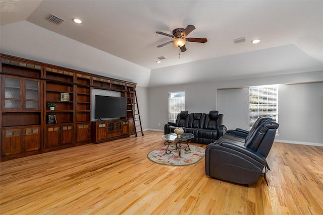 living room featuring ceiling fan, light hardwood / wood-style floors, and lofted ceiling