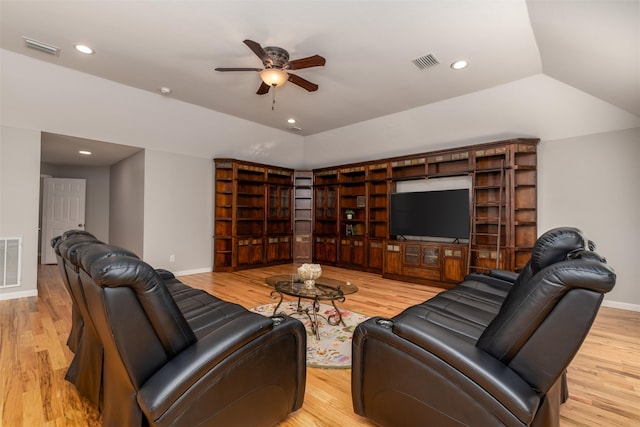 living room featuring ceiling fan, light hardwood / wood-style floors, and vaulted ceiling