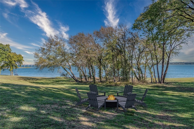 view of yard with a water view and an outdoor fire pit