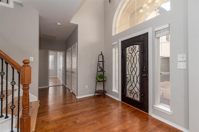 entrance foyer featuring hardwood / wood-style flooring and a high ceiling