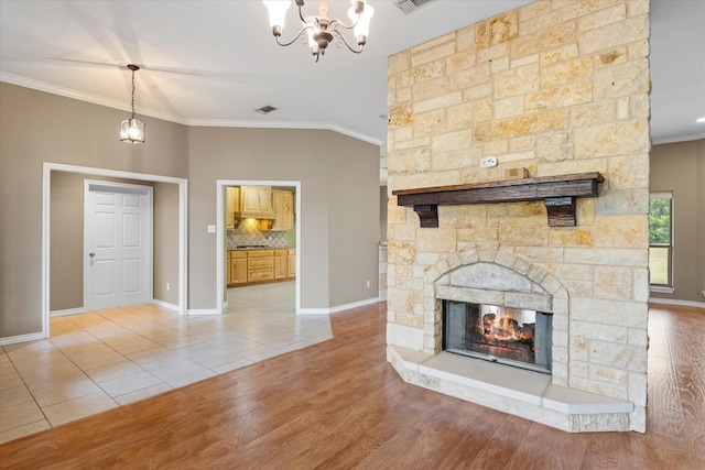 unfurnished living room featuring hardwood / wood-style flooring, ornamental molding, and a fireplace