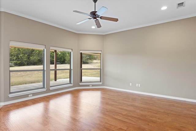 spare room featuring ceiling fan, light hardwood / wood-style floors, and ornamental molding