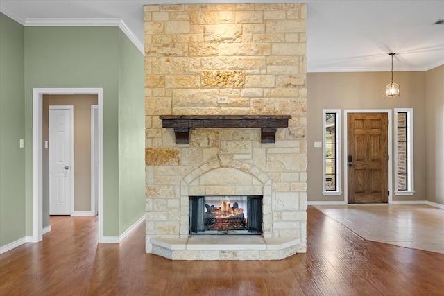 unfurnished living room with crown molding, a fireplace, and hardwood / wood-style flooring