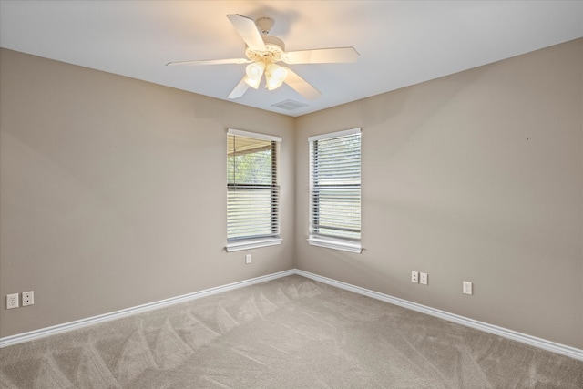 unfurnished room featuring light colored carpet and ceiling fan