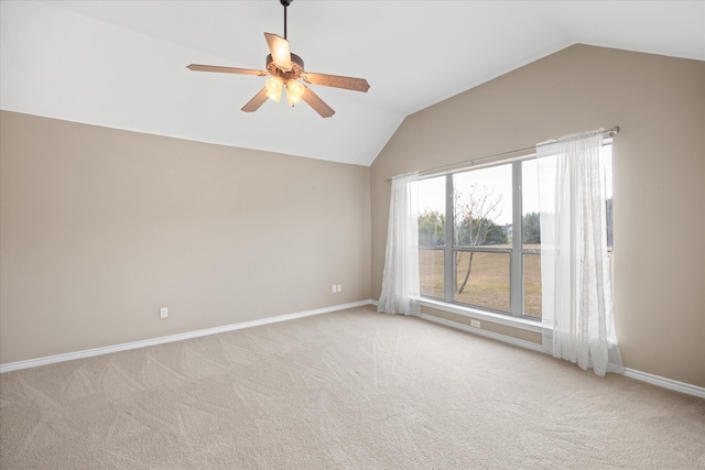 carpeted spare room with ceiling fan and lofted ceiling