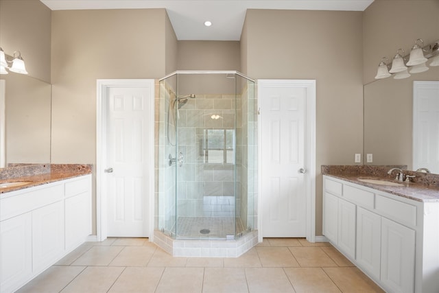 bathroom with tile patterned flooring, vanity, and walk in shower