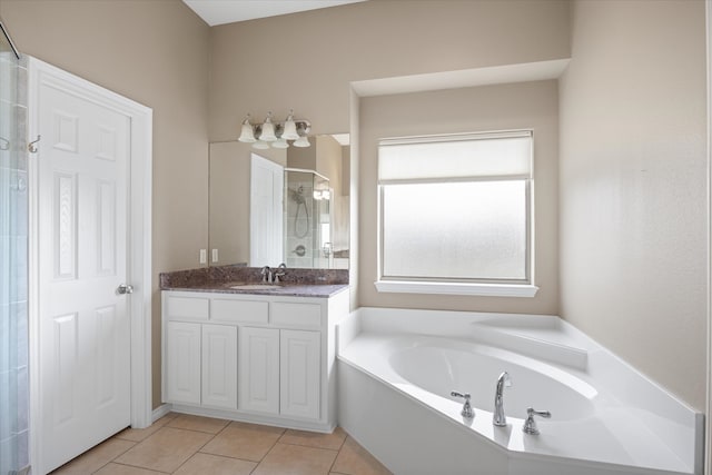 bathroom featuring tile patterned flooring, vanity, and shower with separate bathtub