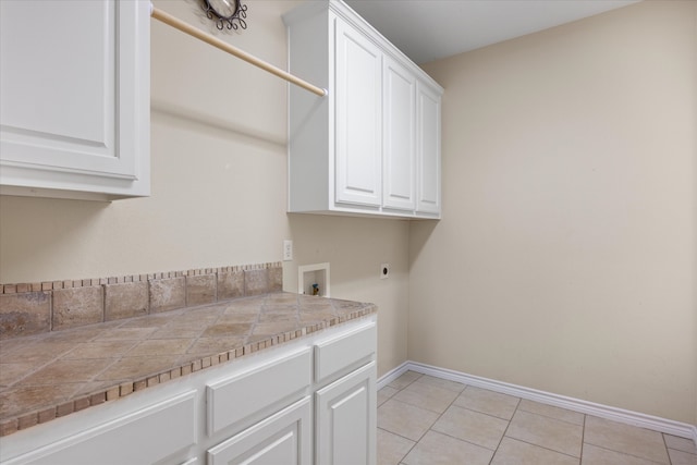 laundry room featuring washer hookup, light tile patterned floors, cabinets, and hookup for an electric dryer