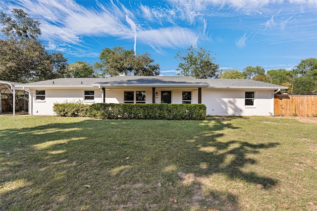 back of property with a lawn