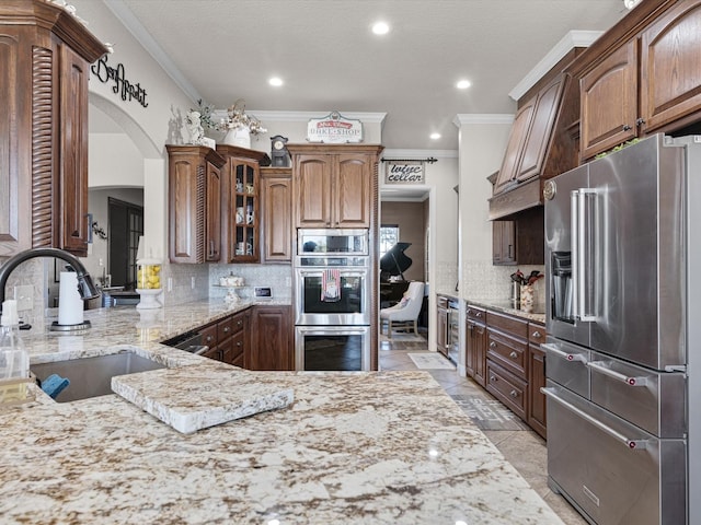 kitchen featuring crown molding, sink, appliances with stainless steel finishes, and tasteful backsplash