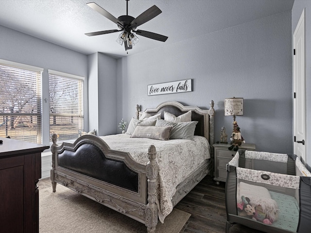 bedroom with ceiling fan and dark hardwood / wood-style flooring