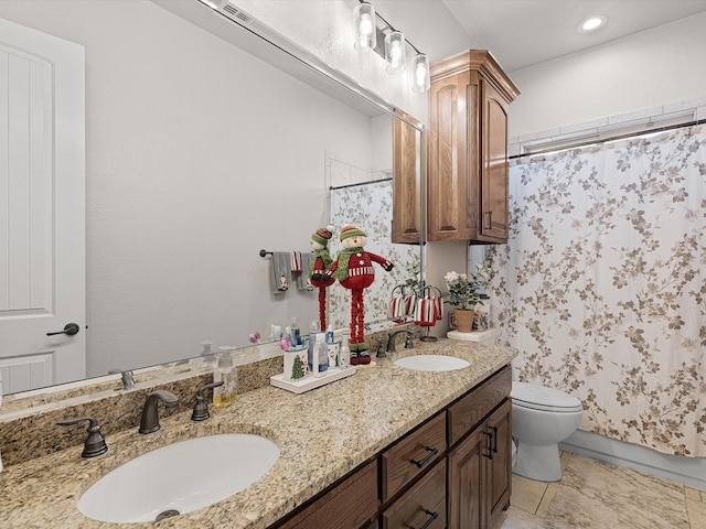 bathroom with tile patterned floors, vanity, and toilet