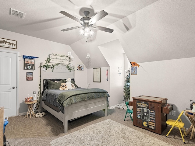 carpeted bedroom featuring a textured ceiling, ceiling fan, and vaulted ceiling