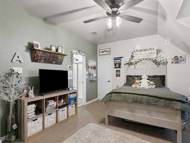 bedroom featuring ceiling fan, light colored carpet, and a textured ceiling