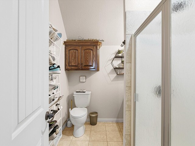 laundry area featuring cabinets, light tile patterned flooring, and washing machine and dryer