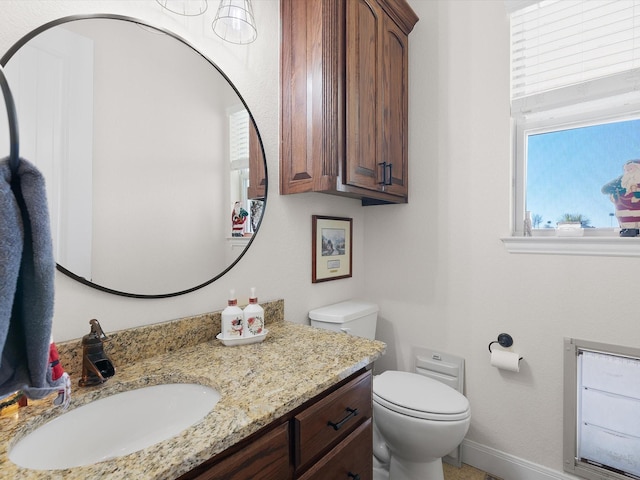 bathroom featuring vanity and toilet