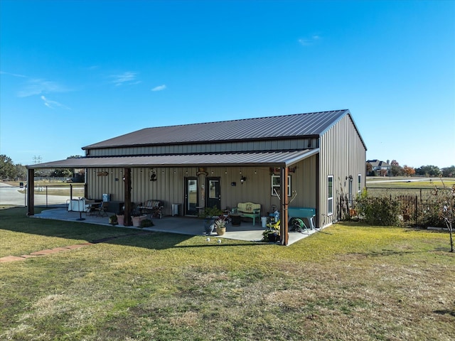 back of house featuring an outdoor hangout area, a patio area, and a yard