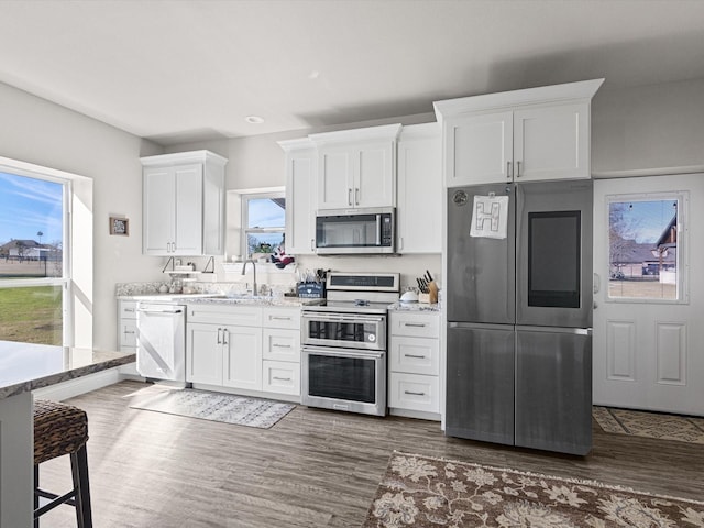 kitchen featuring white cabinetry, dark hardwood / wood-style flooring, and appliances with stainless steel finishes