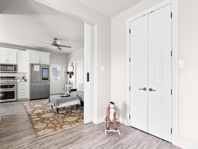 interior space featuring ceiling fan and light hardwood / wood-style floors