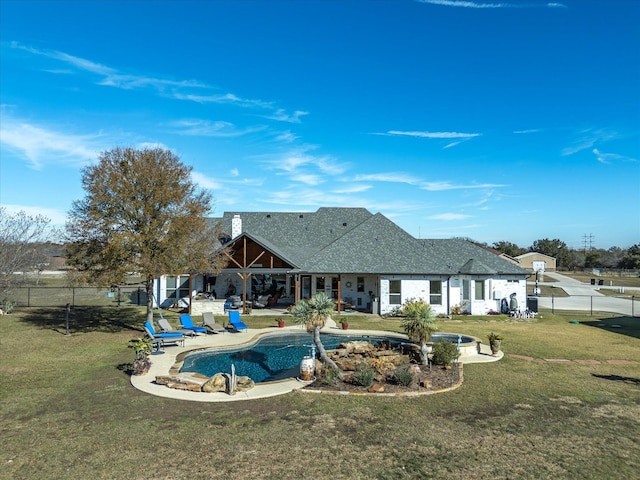 rear view of property featuring a patio area and a lawn