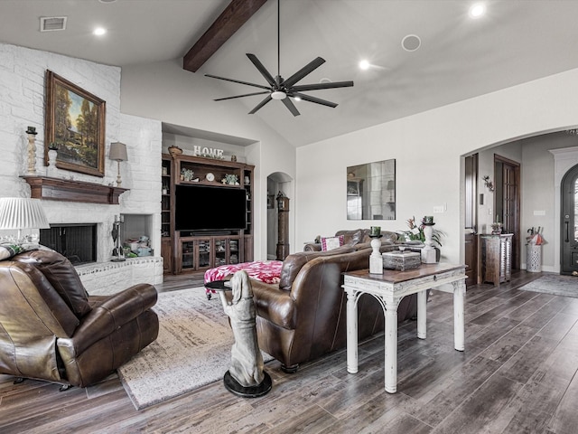 living room featuring dark hardwood / wood-style floors, lofted ceiling with beams, a fireplace, and ceiling fan