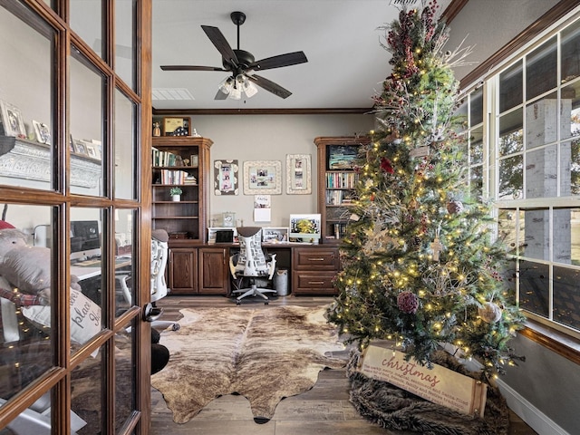 home office featuring hardwood / wood-style floors, ceiling fan, crown molding, and french doors